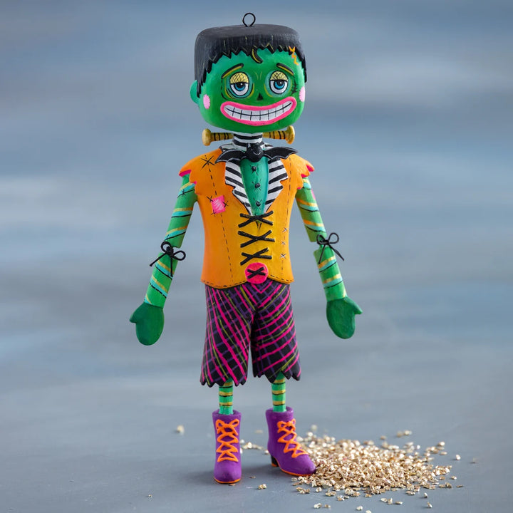 Glitterville Swanky Franky Halloween ornament featuring a colorful green Frankenstein character in an orange vest, striped pants, and purple boots.
