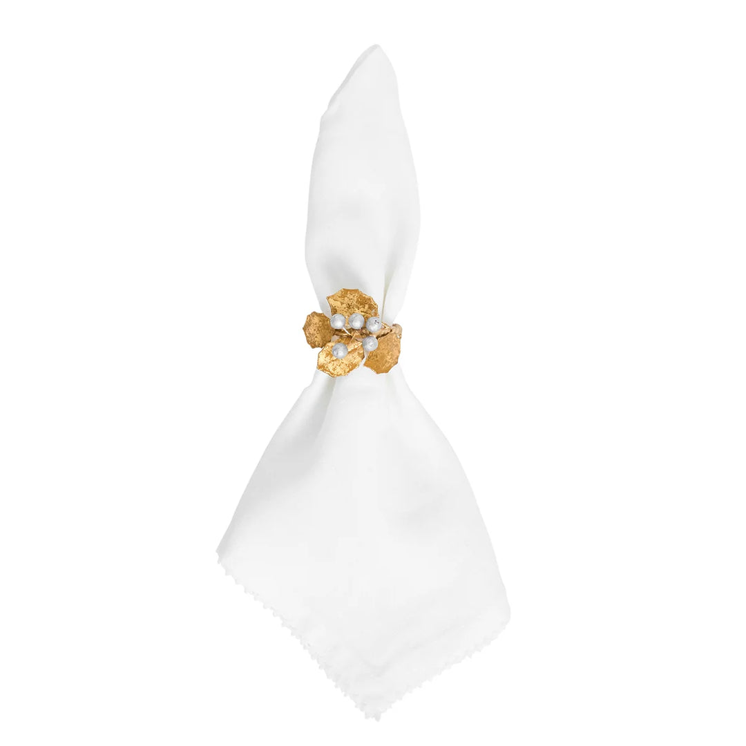 Gold Holly Napkin Ring featuring textured gold leaves and silver berries displayed on a white cloth napkin