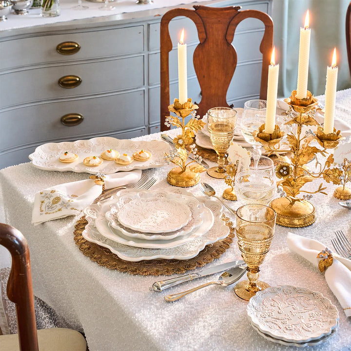 Gold Holly Napkin Rings styled with white linens on an elegant Christmas table with gold holiday accents