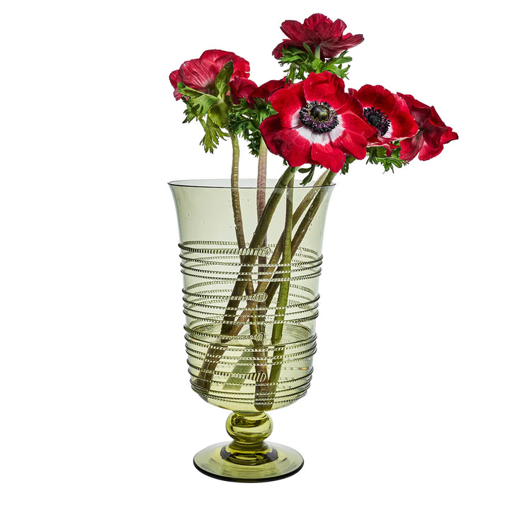 Green glass pedestal hurricane vase filled with red flowers, featuring raised wrapped thread detailing around the glass.