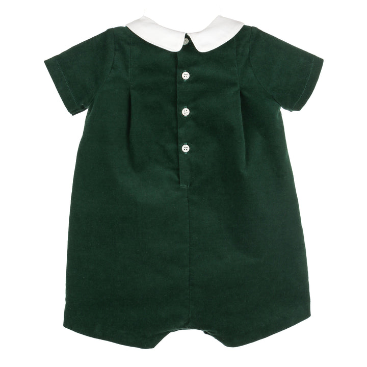 Back view of green velvet Christmas romper with white split collar, short sleeves, and button-back closure.
