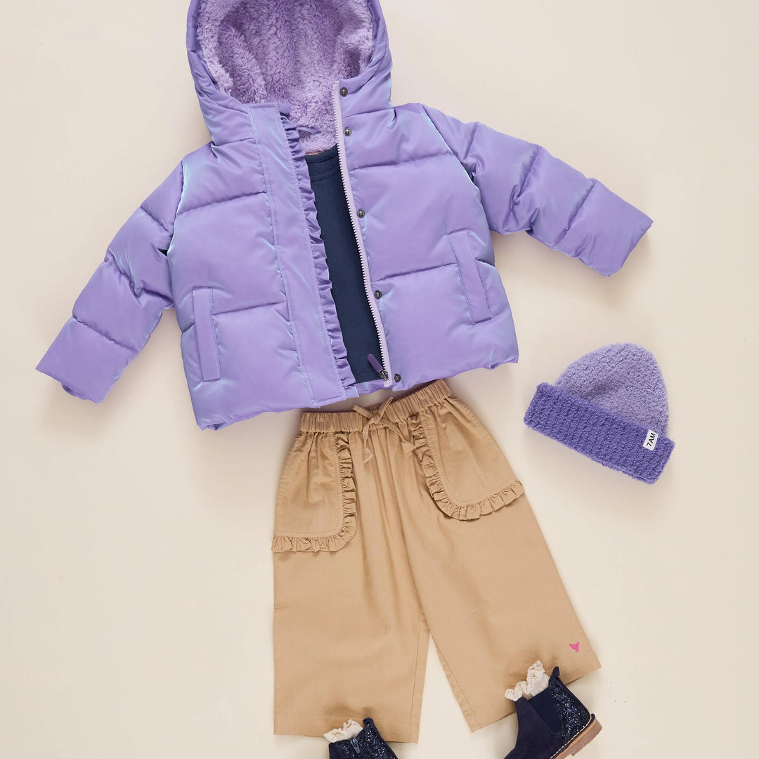Girls Lavender Ruffle Pete Puffer styled with tan pants, purple beanie, and boots