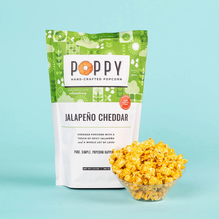 Poppy Jalapeño Cheddar Hand-Crafted Popcorn bag displayed with a bowl of seasoned popcorn.