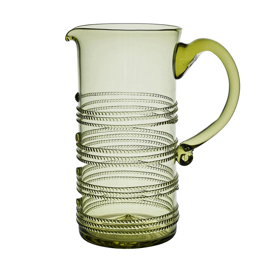 Juliska Amalia Green Pitcher featuring pale green glass, a curved handle, pouring spout and signature wrapped thread detailing.