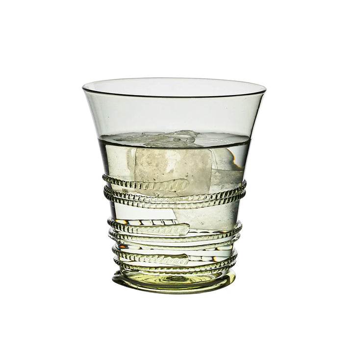 Juliska green glass tumbler filled with ice and water, featuring decorative wrapped thread detailing and a soft green tint.