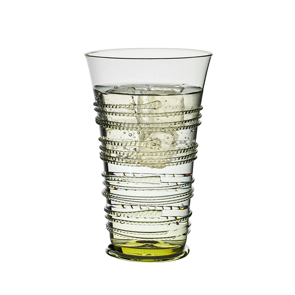 Juliska green glass highball tumbler filled with ice and water, featuring decorative wrapped thread detailing and a green glass base.