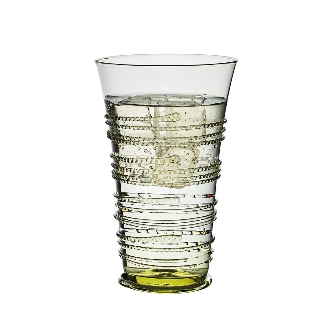 Juliska green glass highball tumbler filled with ice and water, featuring decorative wrapped thread detailing and a green glass base.