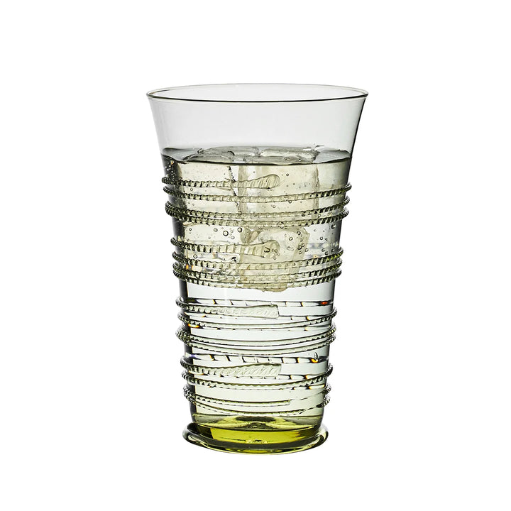 Juliska green glass highball tumbler filled with ice and water, featuring decorative wrapped thread detailing and a green glass base.