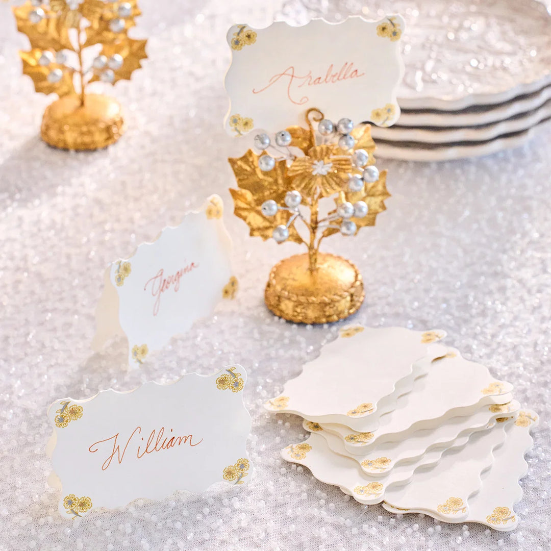 Juliska Holly place cards personalized with guest names and styled with gold floral place card holders for an elegant table setting