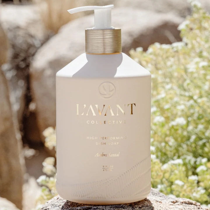L’AVANT Ambre Santal luxury dish soap bottle with white pump and gold collar displayed outdoors on natural stone