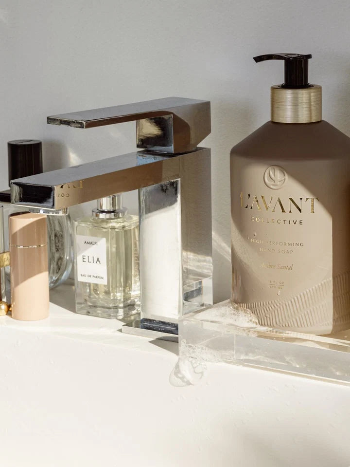 L’AVANT Ambre Santal High Performing Hand Soap displayed beside a modern faucet on a bathroom vanity