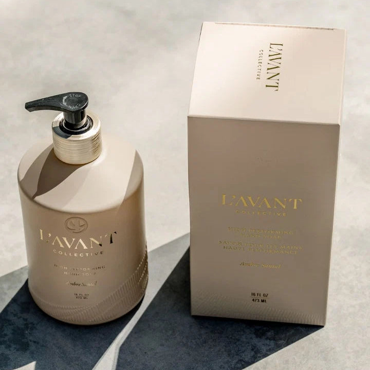 L’AVANT Ambre Santal High Performing Hand Soap 16 oz bottle and coordinating box displayed in natural sunlight