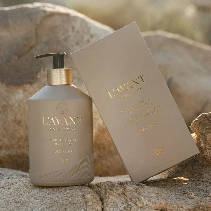 L’AVANT Ambre Santal High Performing Hand Soap 16 oz bottle with coordinating box styled outdoors on natural rock