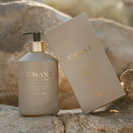 L’AVANT Ambre Santal High Performing Hand Soap 16 oz pump bottle with coordinating product box displayed on natural stone