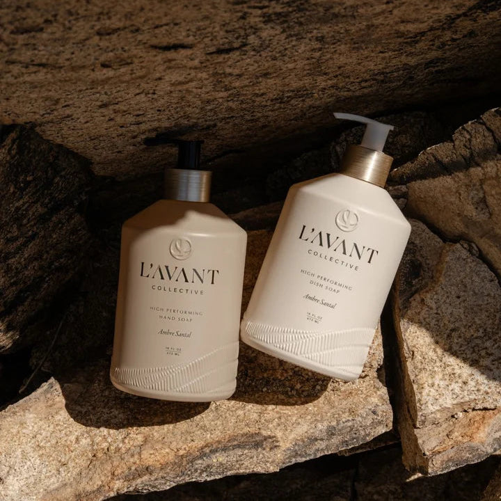 L’AVANT Ambre Santal High Performing Hand Soap and Dish Soap bottles styled together on natural stone