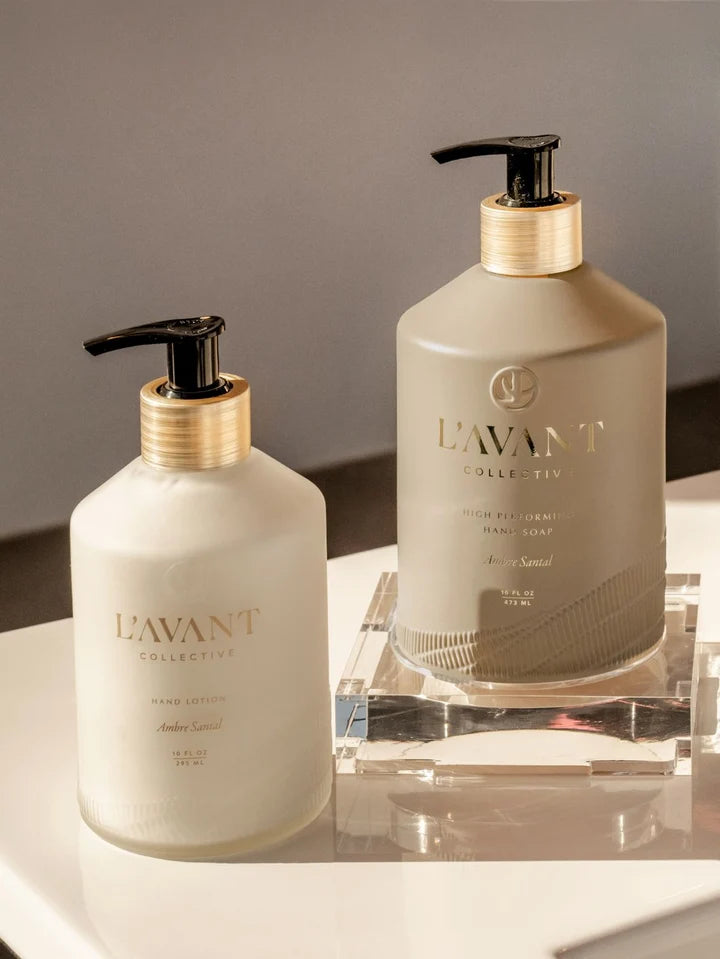 L’AVANT Ambre Santal High Performing Hand Soap and Hand Lotion displayed together on a clear acrylic tray