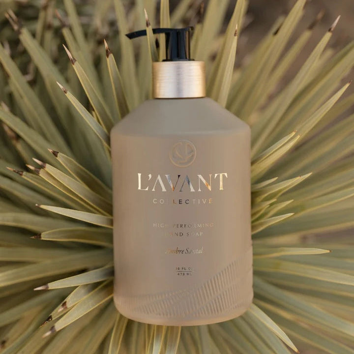 L’AVANT Ambre Santal High Performing Hand Soap styled outdoors against green desert foliage