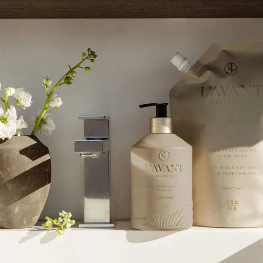 L’AVANT Ambre Santal High Performing Hand Soap bottle and 32 oz refill pouch displayed beside a modern sink