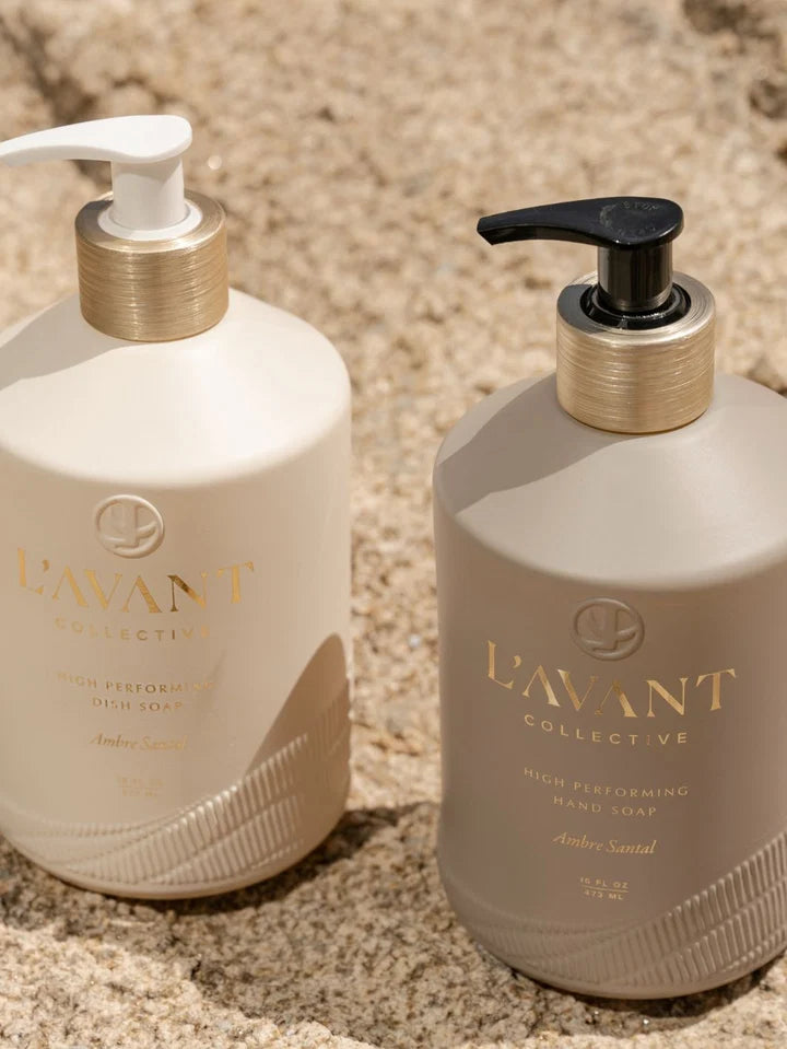 L’AVANT Ambre Santal High Performing Hand Soap and Dish Soap 16 oz bottles styled outdoors on natural stone