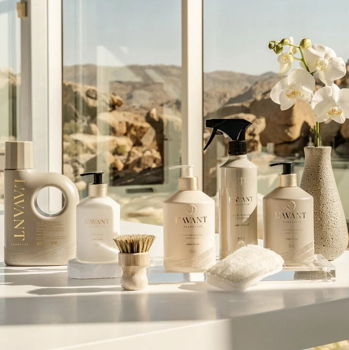 L’AVANT Collective Ambre Santal laundry detergent and home cleaning products displayed by a window