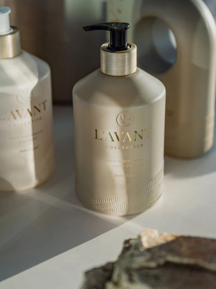L’AVANT Ambre Santal High Performing Hand Soap 16 oz pump bottle styled in warm natural sunlight