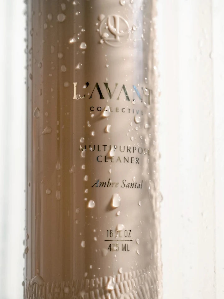 Close-up of L’AVANT Collective Ambre Santal multipurpose cleaner bottle with water droplets