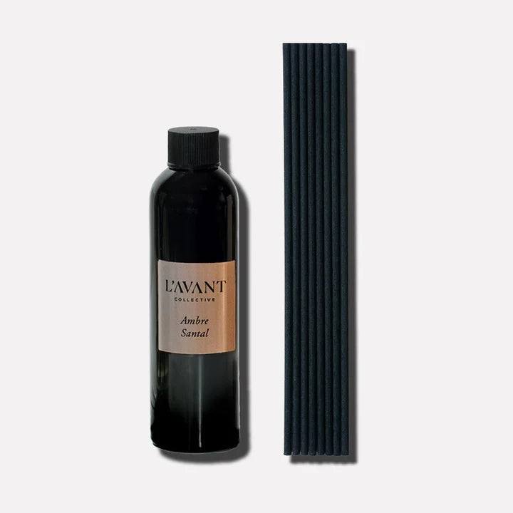 L’AVANT Collective Ambre Santal reed diffuser refill oil with black replacement diffuser reeds.