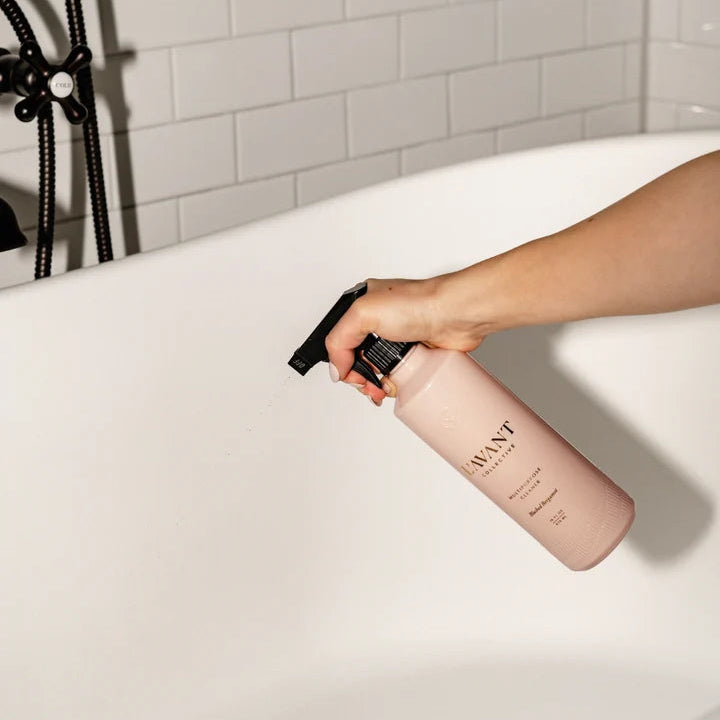 L’AVANT Blushed Bergamot Multipurpose Cleaner being used to clean a white bathtub