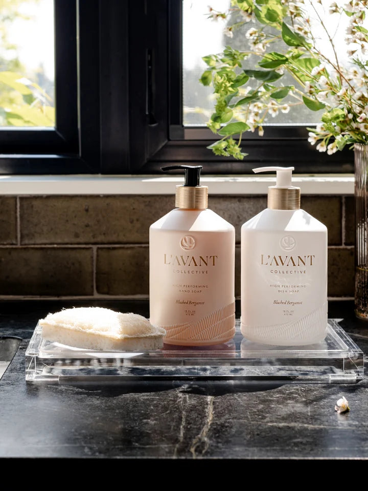 L’AVANT Blushed Bergamot hand soap and dish soap displayed on a clear lucite tray in a modern kitchen