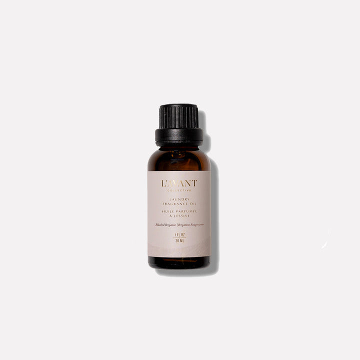 L’AVANT Collective Blushed Bergamot Laundry Fragrance Oil in a 1 oz amber glass bottle on a white background.