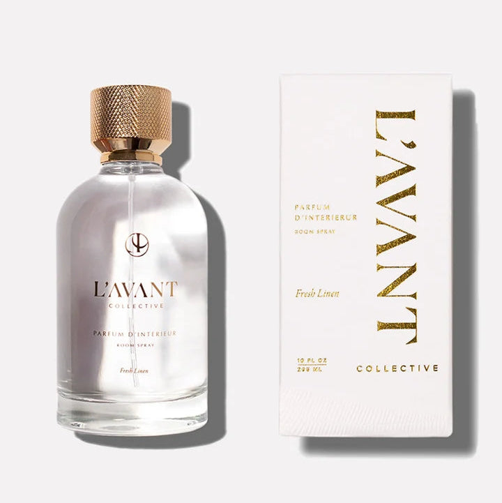 L’AVANT Collective Fresh Linen Parfum d’Intérieur Room Spray displayed with its coordinating white and gold box.