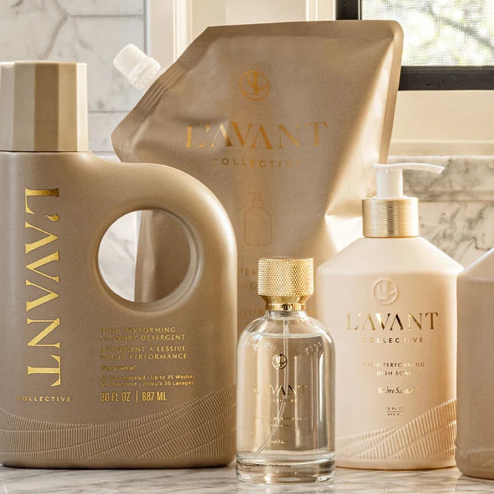 L’AVANT Collective room spray styled with coordinating luxury laundry and home cleaning products for an elevated home fragrance display.