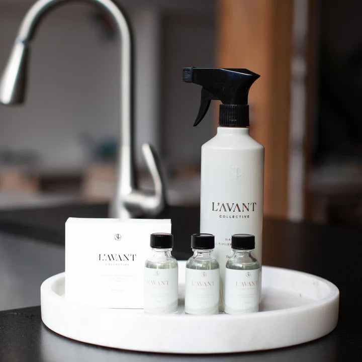 L’AVANT Fresh Linen multipurpose cleaner spray bottle with three concentrated cleaner refills displayed on a tray