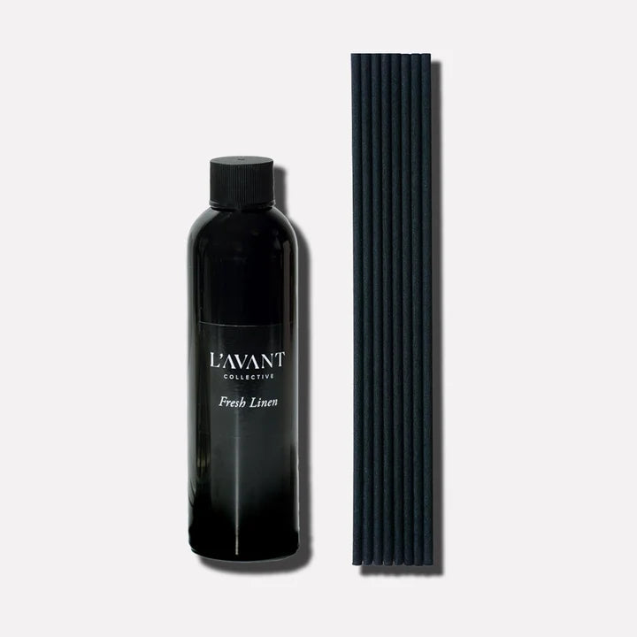L’AVANT Collective Fresh Linen reed diffuser refill oil with black replacement diffuser reeds.