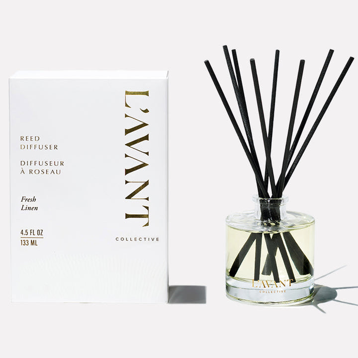 L’AVANT Collective Fresh Linen reed diffuser with black reeds and white and gold product packaging.