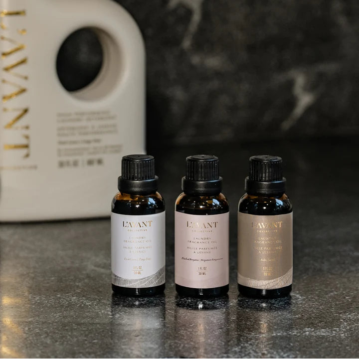 L’AVANT Collective Laundry Fragrance Oil collection featuring Fresh Linen, Blushed Bergamot, and Ambre Santal scents.