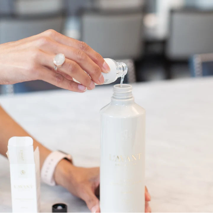 L’AVANT multipurpose cleaner concentrate being poured into a reusable surface cleaner spray bottle