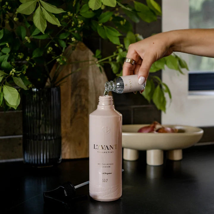 L’AVANT Blushed Bergamot Multipurpose Cleaner bottle being refilled on a kitchen counter