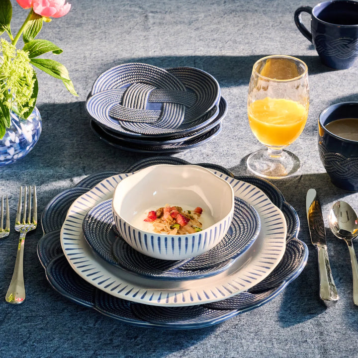 Le Panier Mystic Knot Footed Bowl in Denim styled for entertaining, featuring a classic woven design with distinctive blue knot accents.