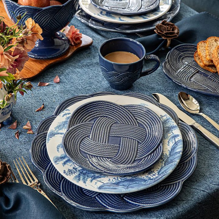 Le Panier Mystic Knot Dessert/Salad Plate in Denim layered in an elegant place setting with coordinating blue and white tableware.