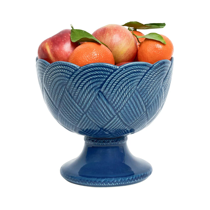 Angled view of the Le Panier Mystic Knot Footed Bowl in Denim showcasing its woven texture, footed base, and blue knot detailing.