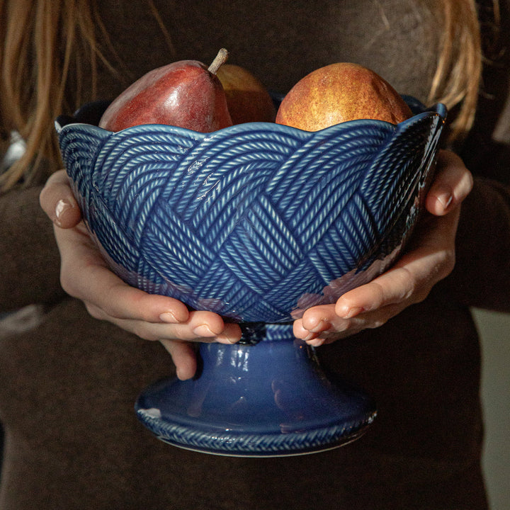 Le Panier Mystic Knot Footed Bowl in Denim displayed in an elegant blue and white tablescape for serving and entertaining.
