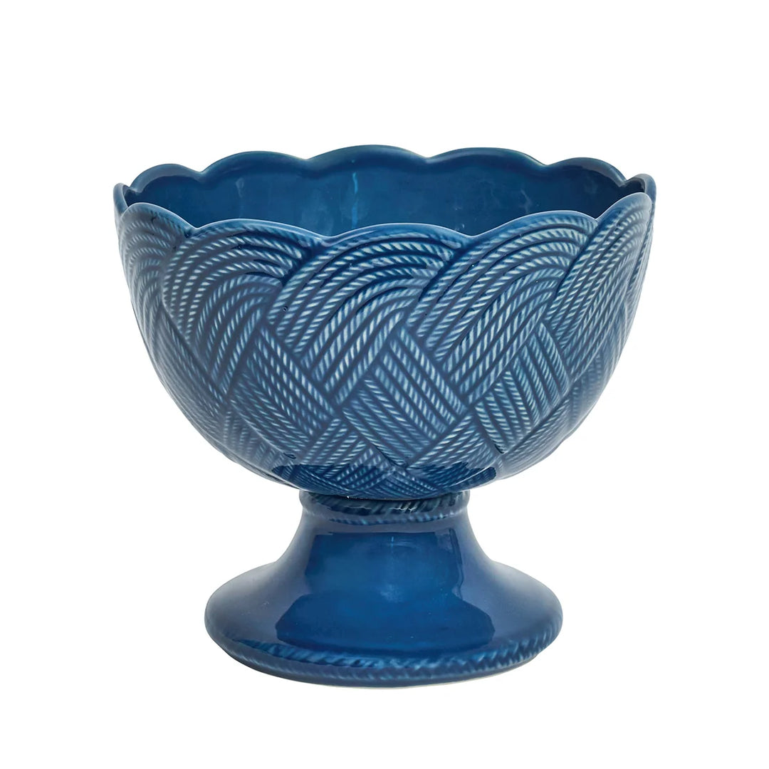 Le Panier Mystic Knot Footed Bowl in Denim featuring a woven basketweave design, pedestal base, and decorative blue mystic knot accents.