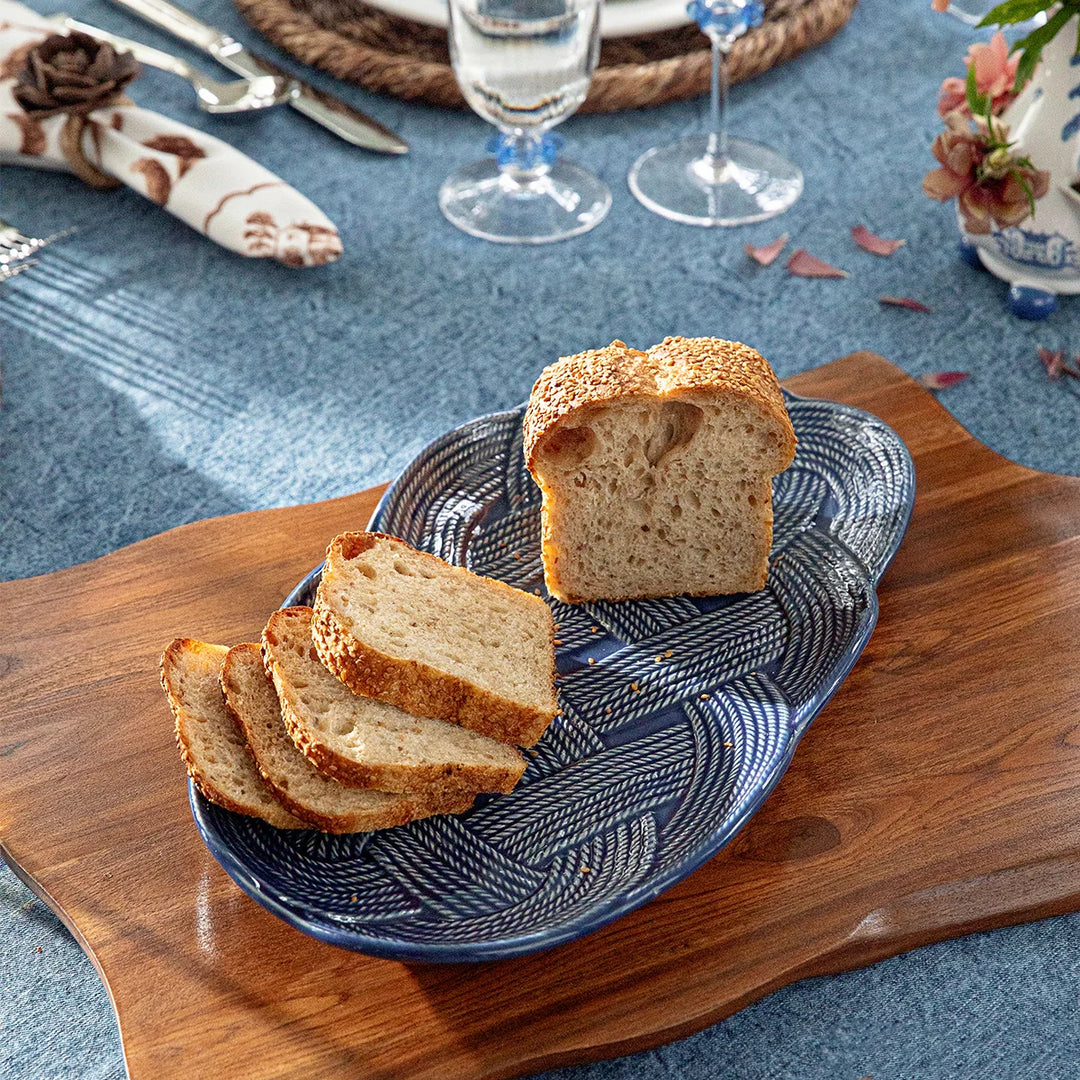 Le Panier Mystic Knot Hostess Tray in Denim displayed in an elegant tablescape with coordinating blue and white tableware.