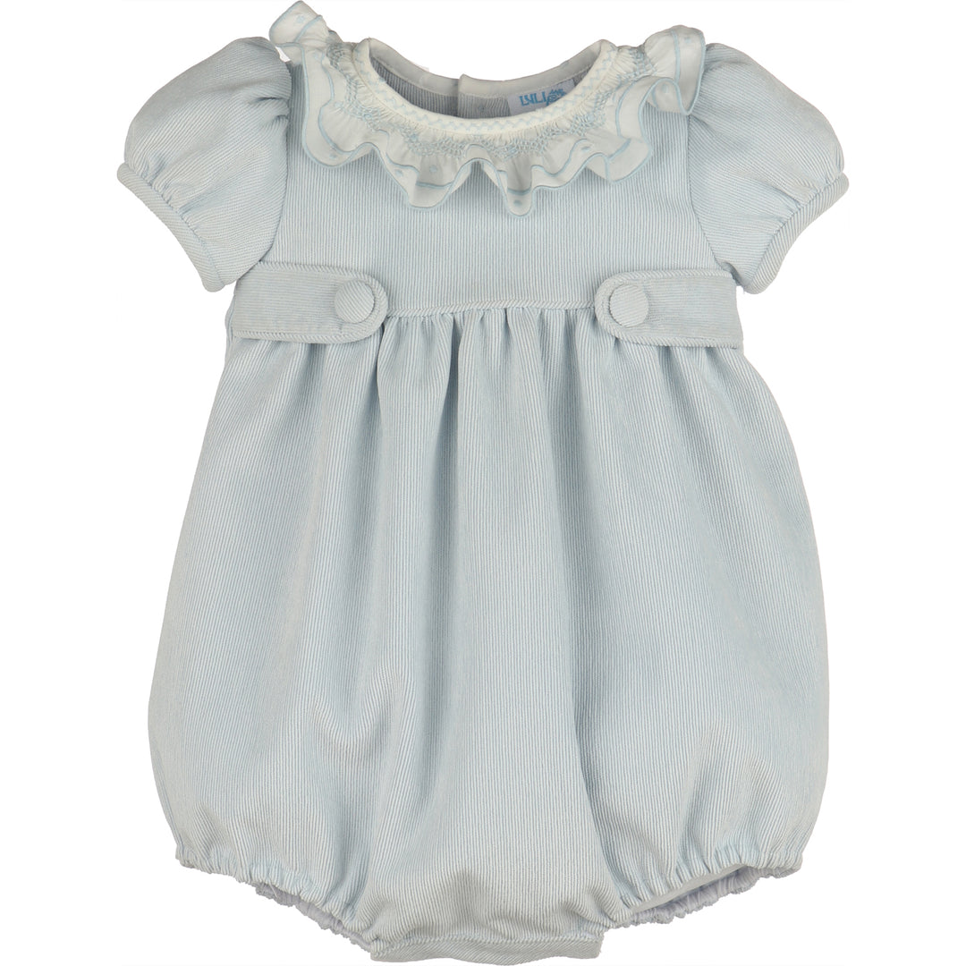 Front view of light blue corduroy baby girl bubble with white smocked ruffle collar, puff sleeves, covered button tabs, and elastic leg openings.