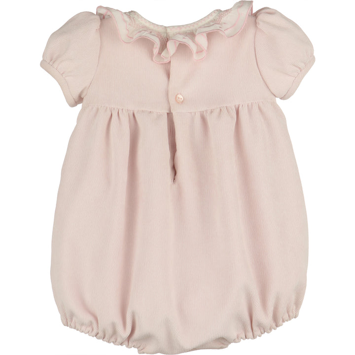 Back view of light pink corduroy baby girl bubble with white ruffle collar, puff sleeves, button-back closure, gathered waist, and elastic leg openings.