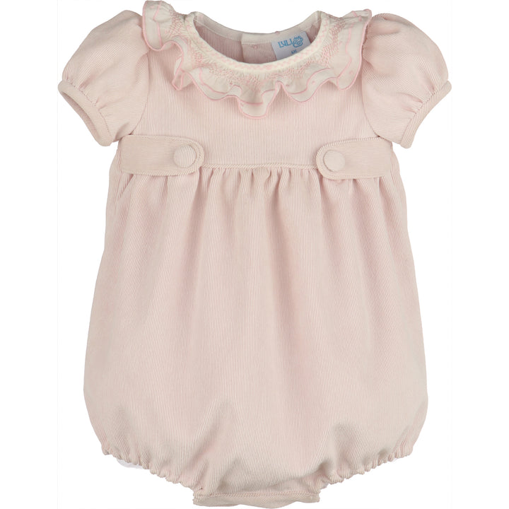 Front view of light pink corduroy baby girl bubble with white smocked ruffle collar, puff sleeves, covered button tabs, and elastic leg openings.
