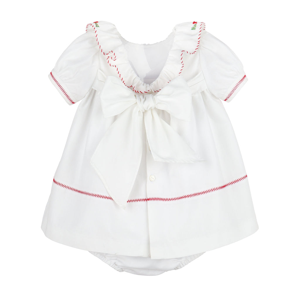 Back view of Merrymaker embroidered Christmas dress with red stitching, ruffled neckline, oversized back bow, and coordinating bloomer.
