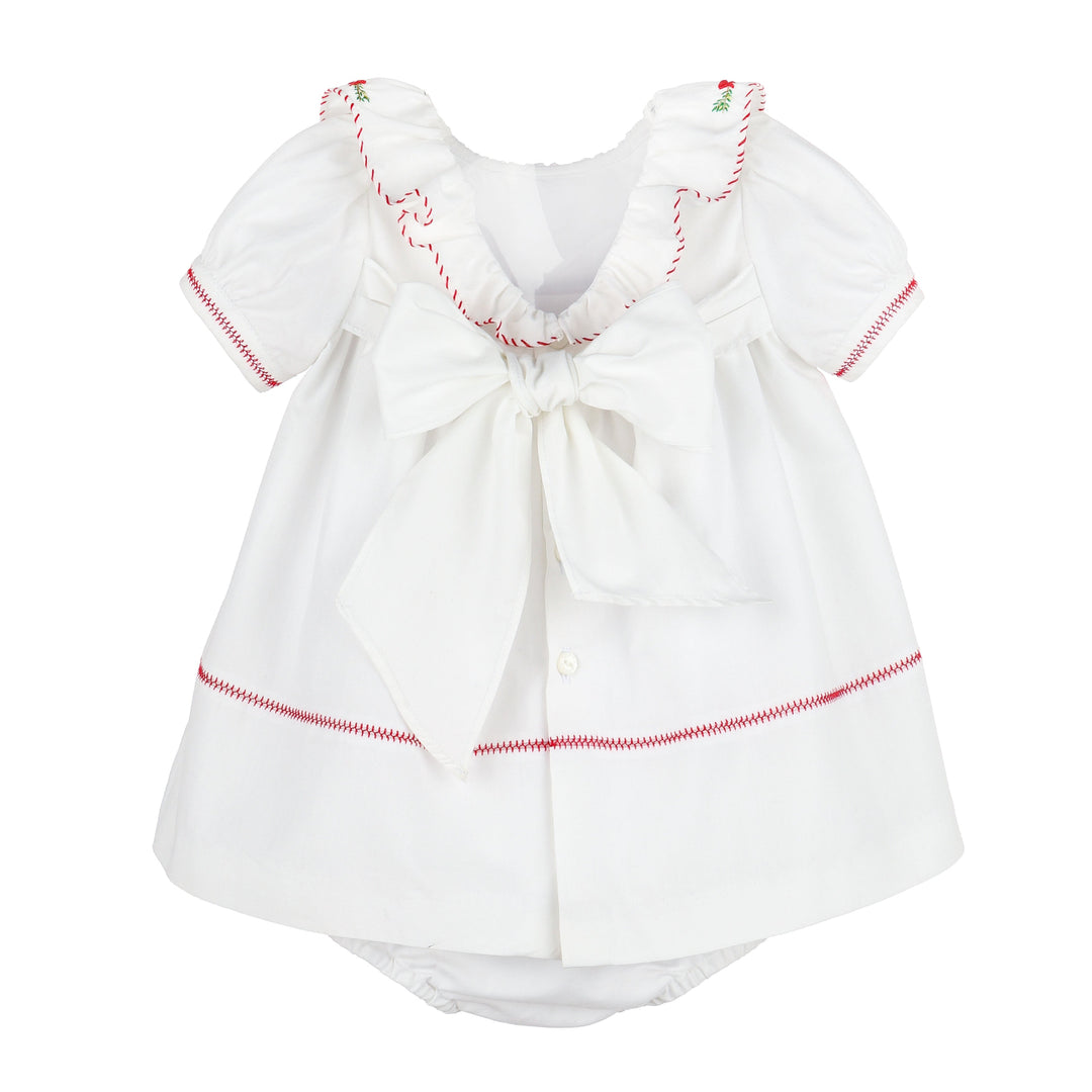 Back view of Merrymaker embroidered Christmas dress with red stitching, ruffled neckline, oversized back bow, and coordinating bloomer.
