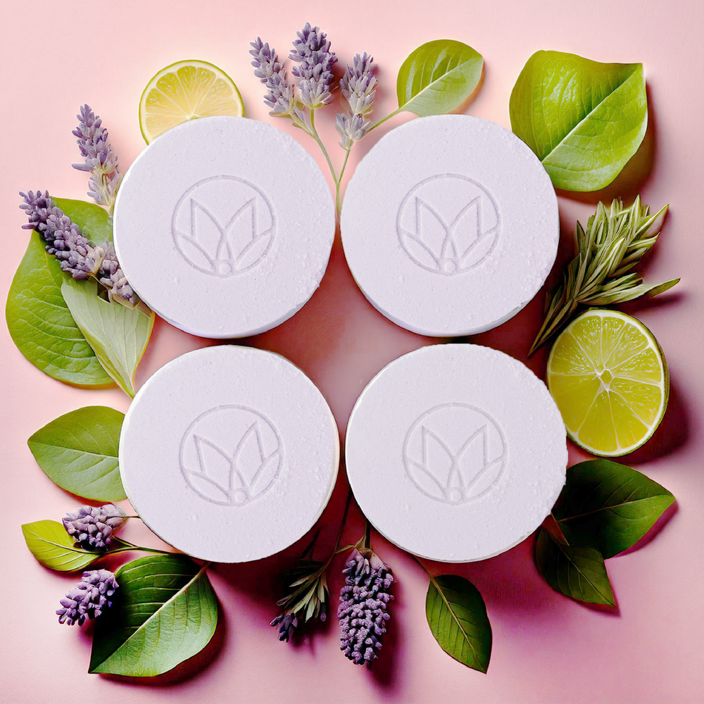 Musee's Lavender & Lime Shower Steamers displayed with the ingredients displayed around them in a circle shape. 